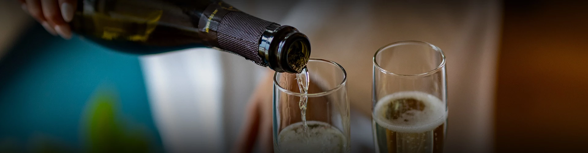 a bottle of wine being poured into a glass