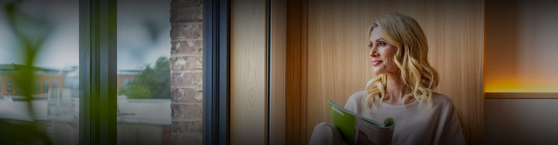 a person sitting in a chair reading a book