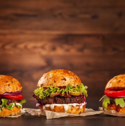 Front view of three tasty hamburgers 