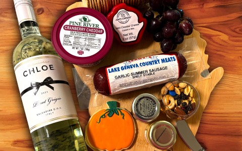 a bottle of wine and food on a wood surface