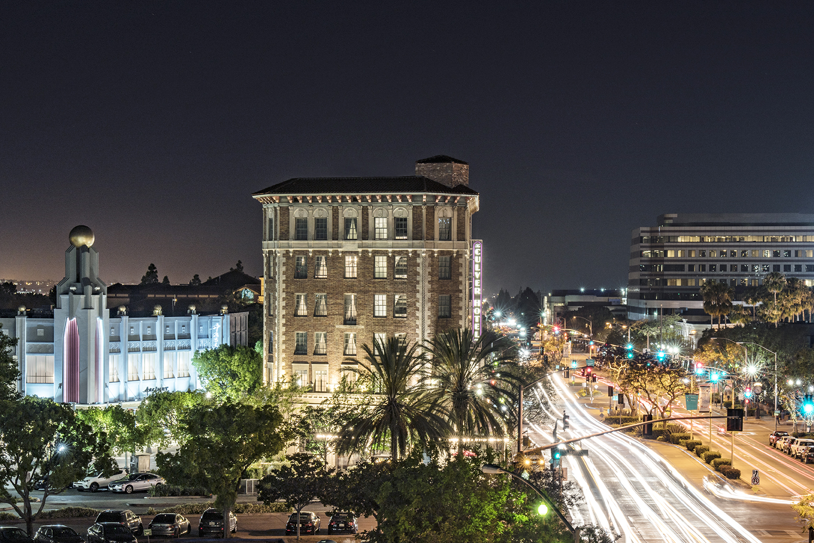 a building with lights on the side of the road