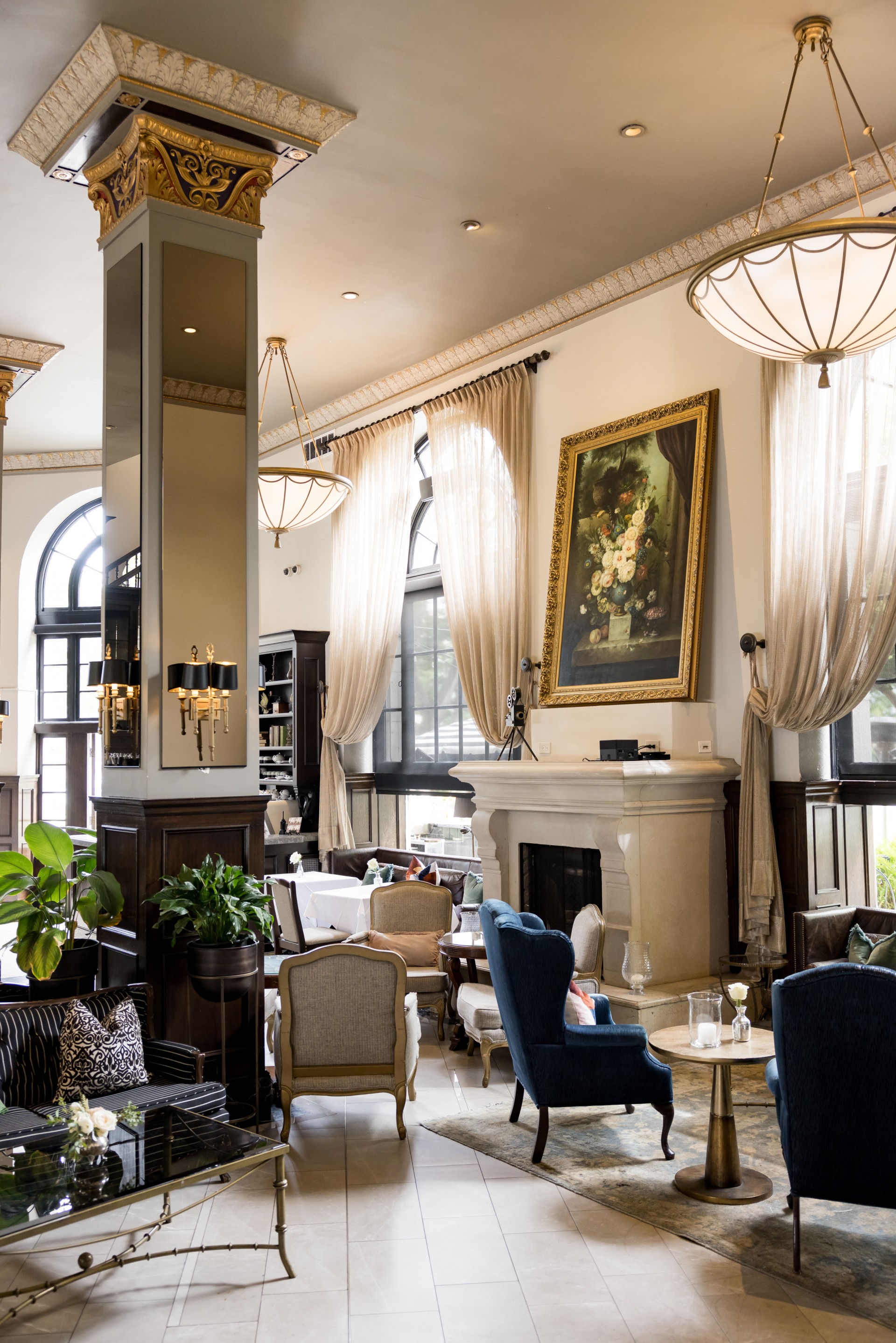 a room with a fireplace and chairs