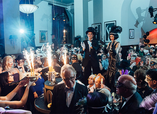 a group of people in a room with a large crowd of people