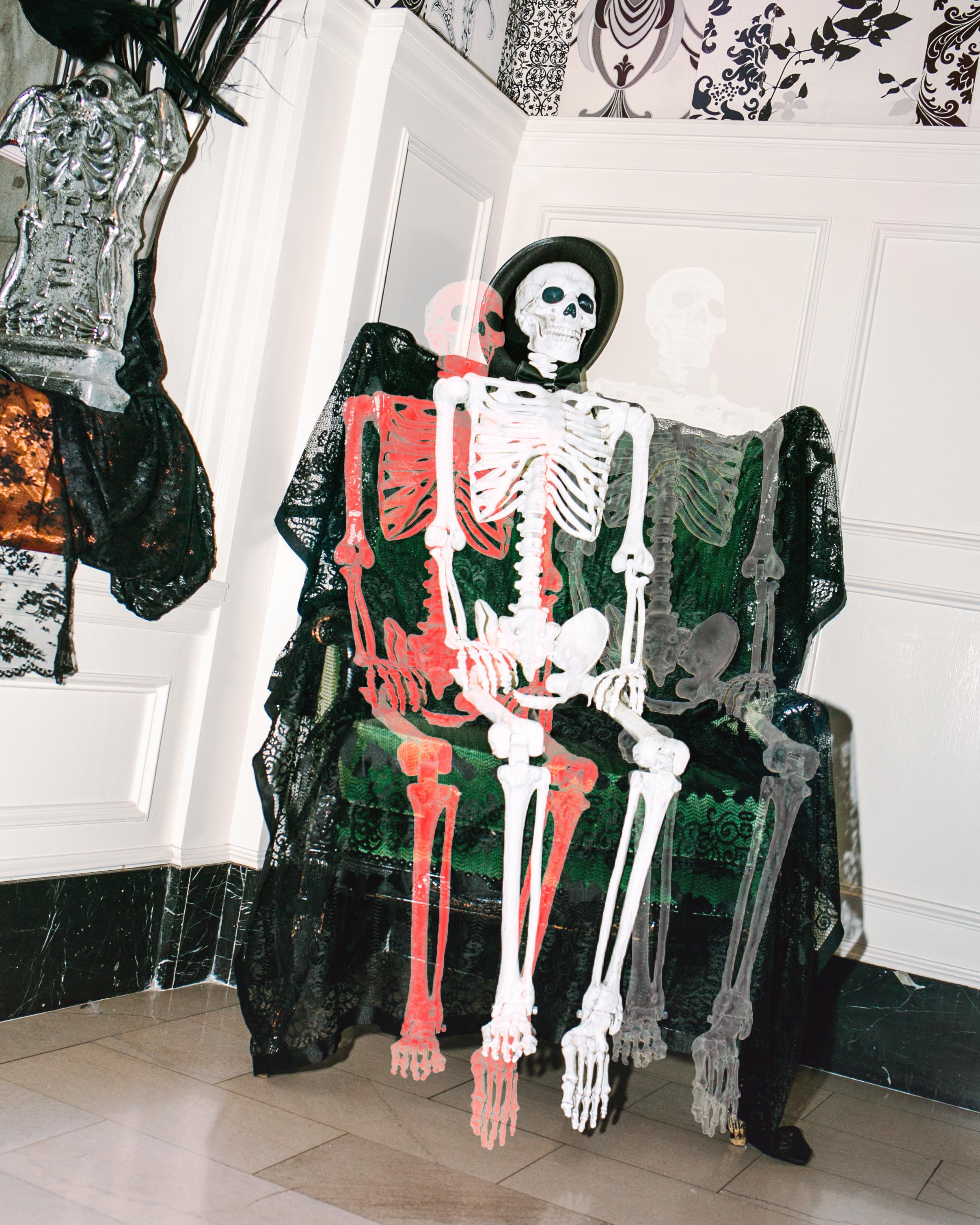 a skeleton sitting on a chair