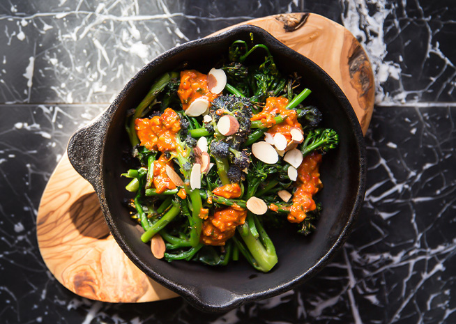 a bowl of broccoli and almonds