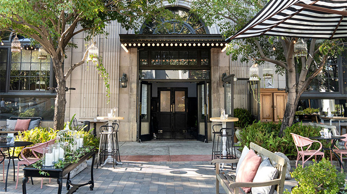 a building with a black door and chairs