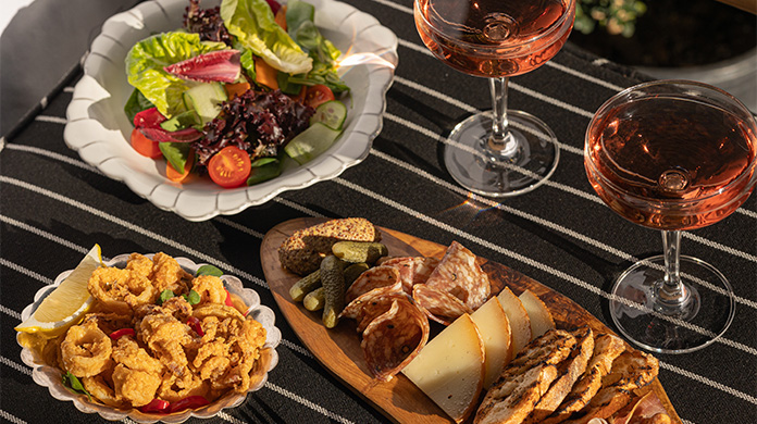 a plate of food and a glass of wine