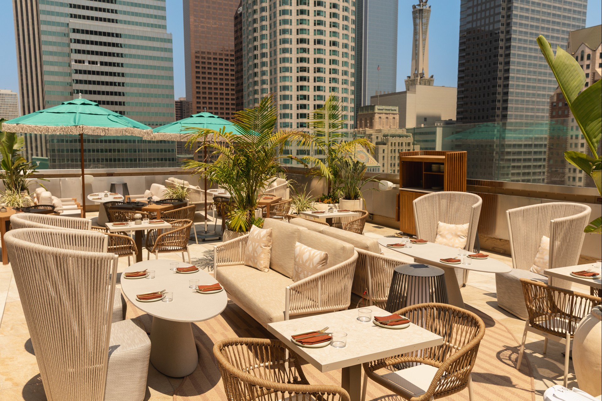 a rooftop restaurant with a city skyline in the background