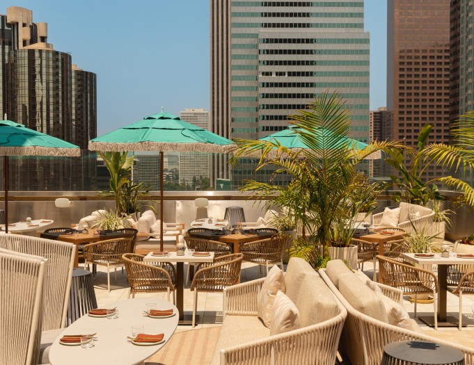 a rooftop restaurant with tables and umbrellas