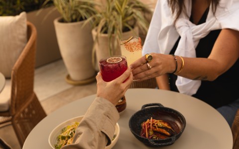 a couple of people holding drinks