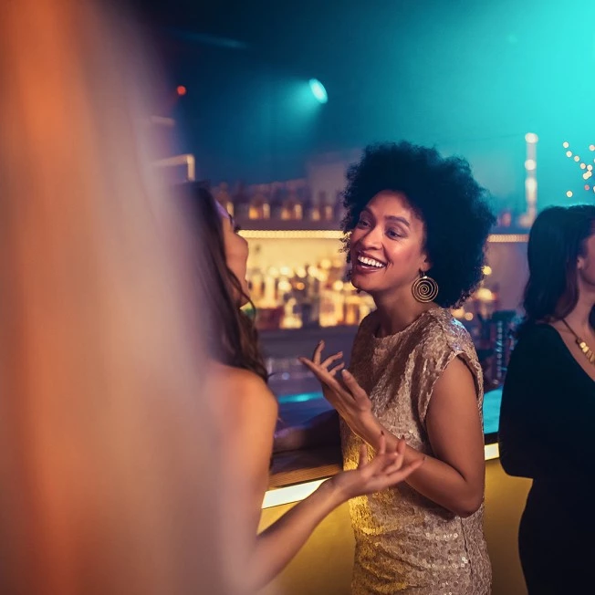 A group of people socializing at a bar