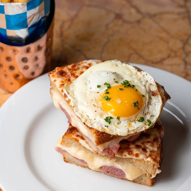 A Croque Monsieur sandwich with egg on top
