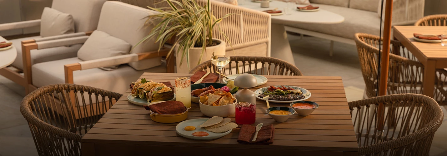 A table with food and drinks in a restaurant setting.