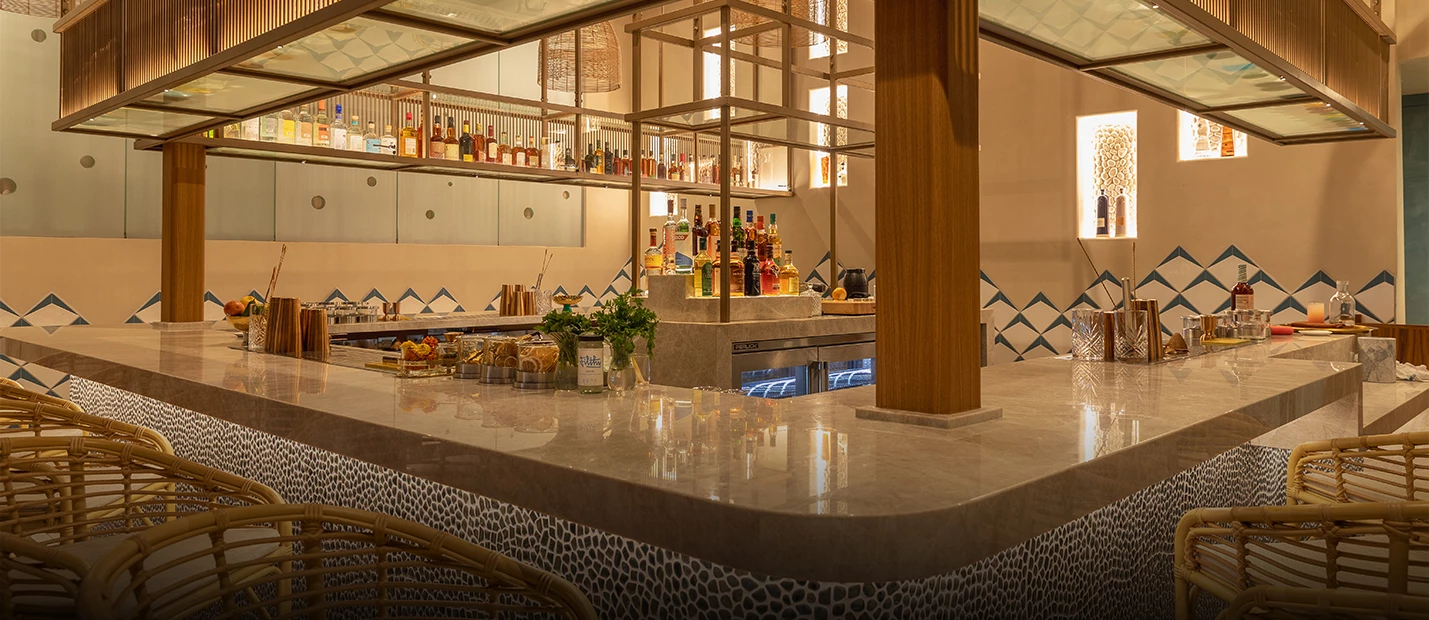 a bar with bottles of alcohol on the counter