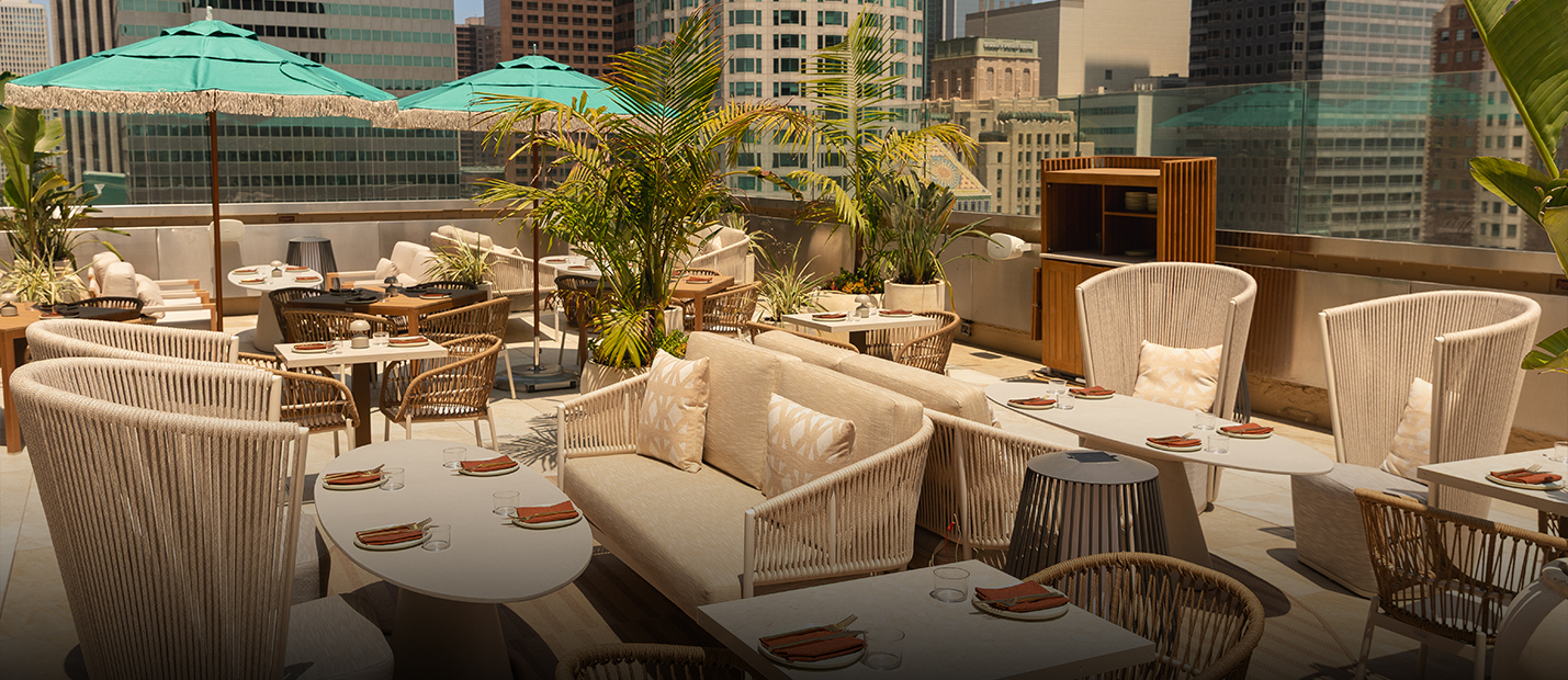 a patio with tables and chairs and umbrellas