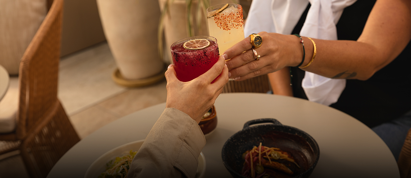 a pair of hands holding drinks