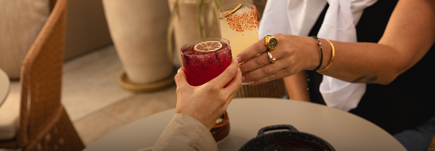 a pair of hands holding drinks