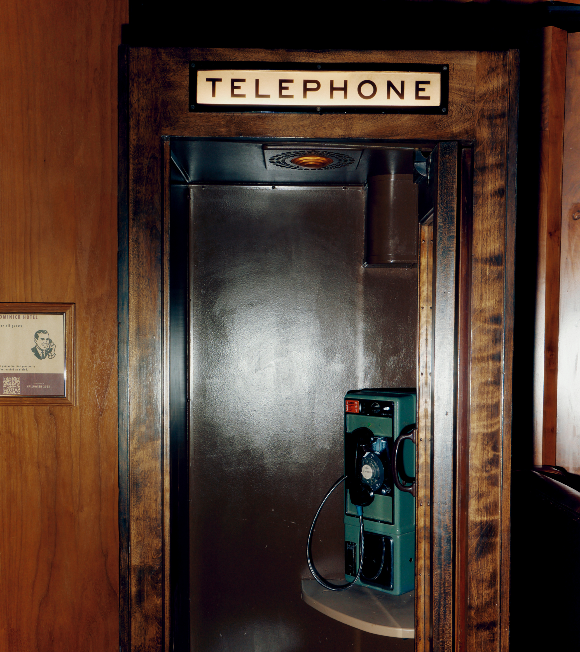 a telephone booth with a sign