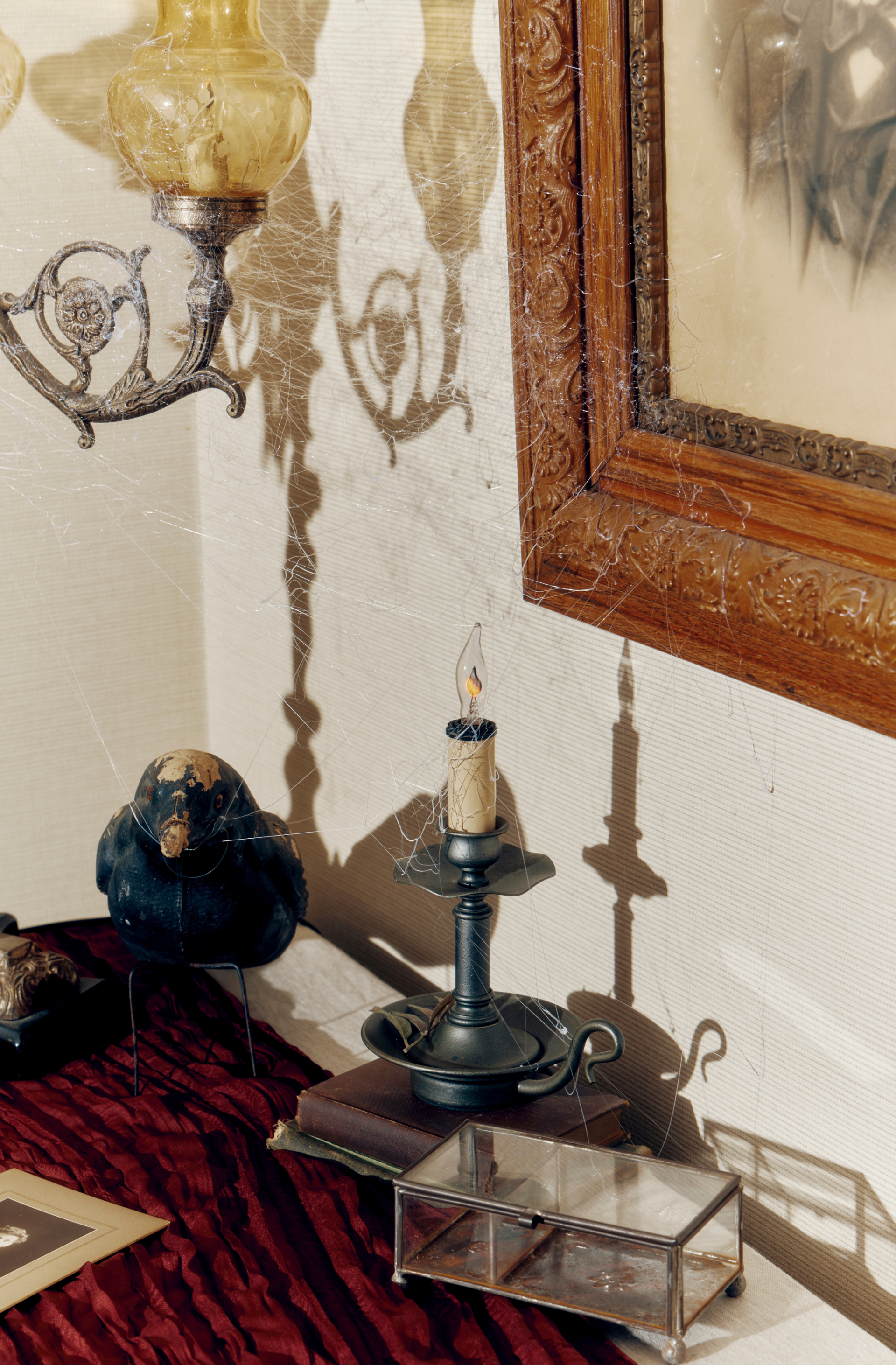a candle on a candle holder next to a candle and a picture frame