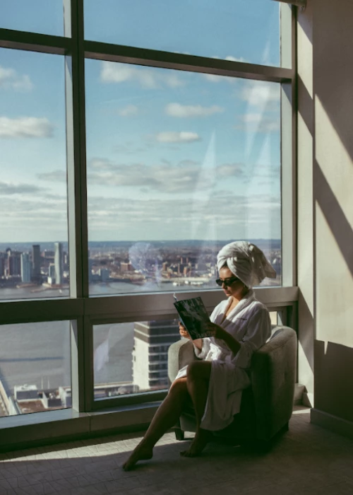 a person sitting on a chair reading a book