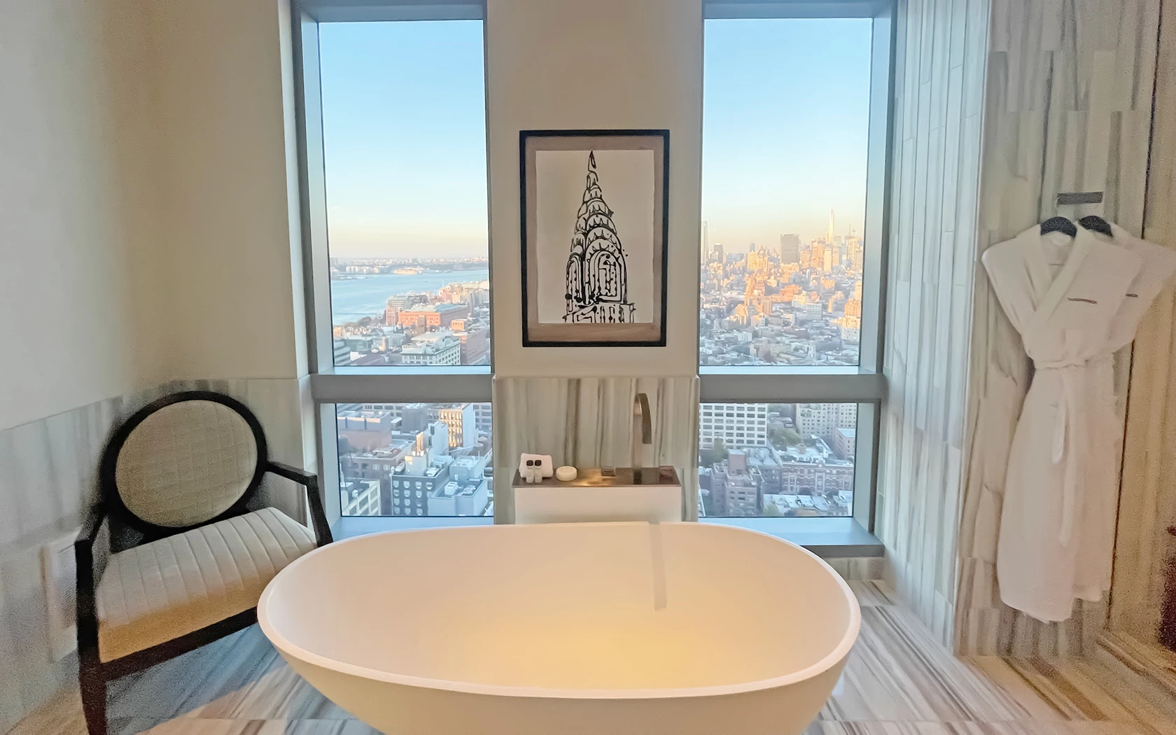 bathroom with bathtub and new york city view behind