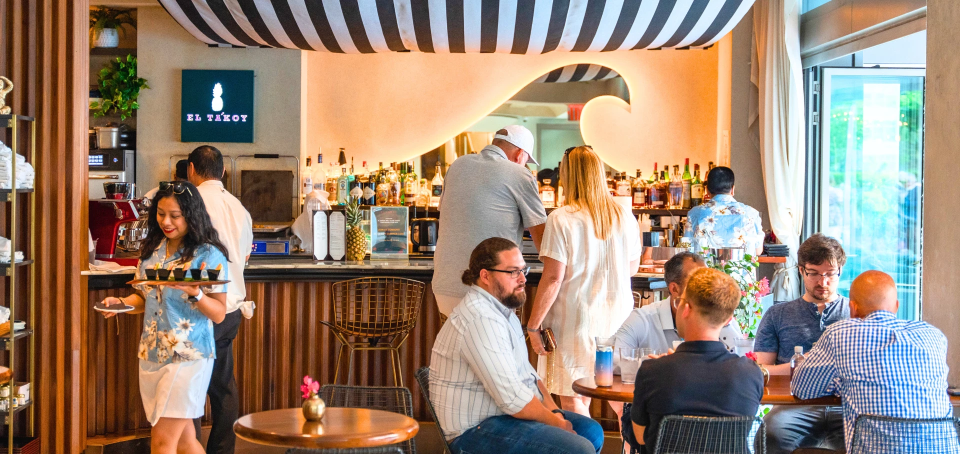 a group of people sitting at a bar