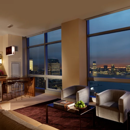 a living room with a view of a city skyline