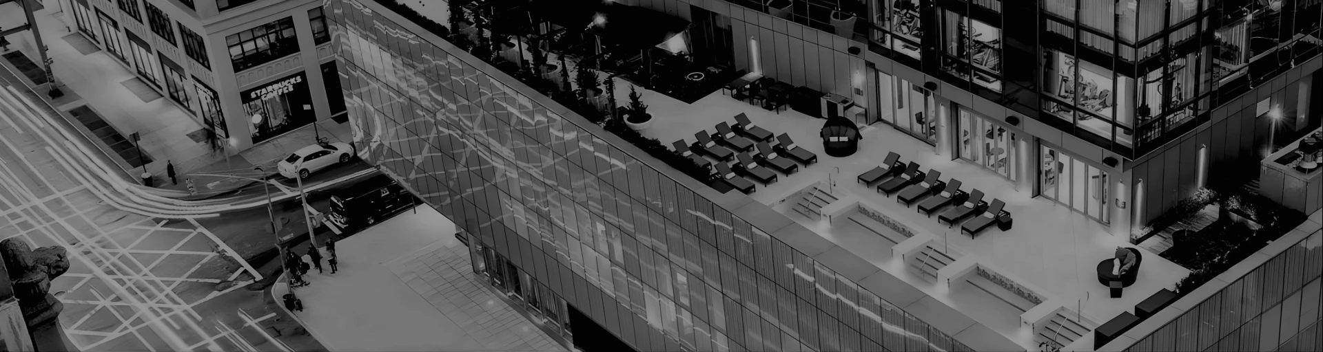 a building with a pool and chairs