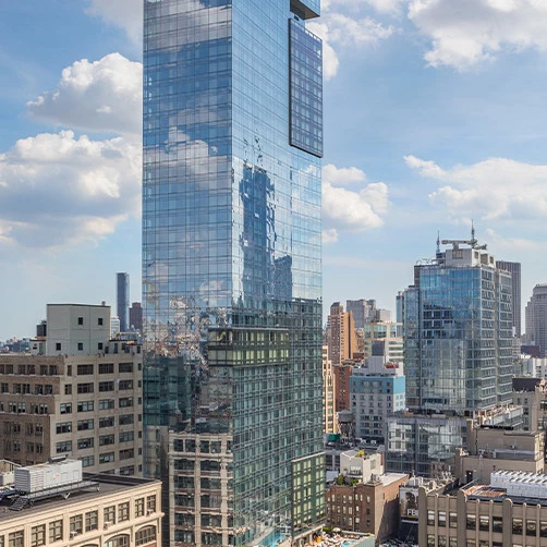 a tall glass building in a city