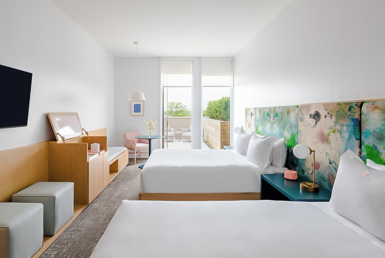 a room with two beds and a piano