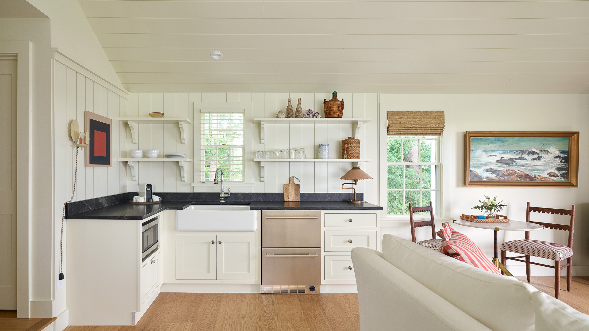 a kitchen with white cabinets and white furniture