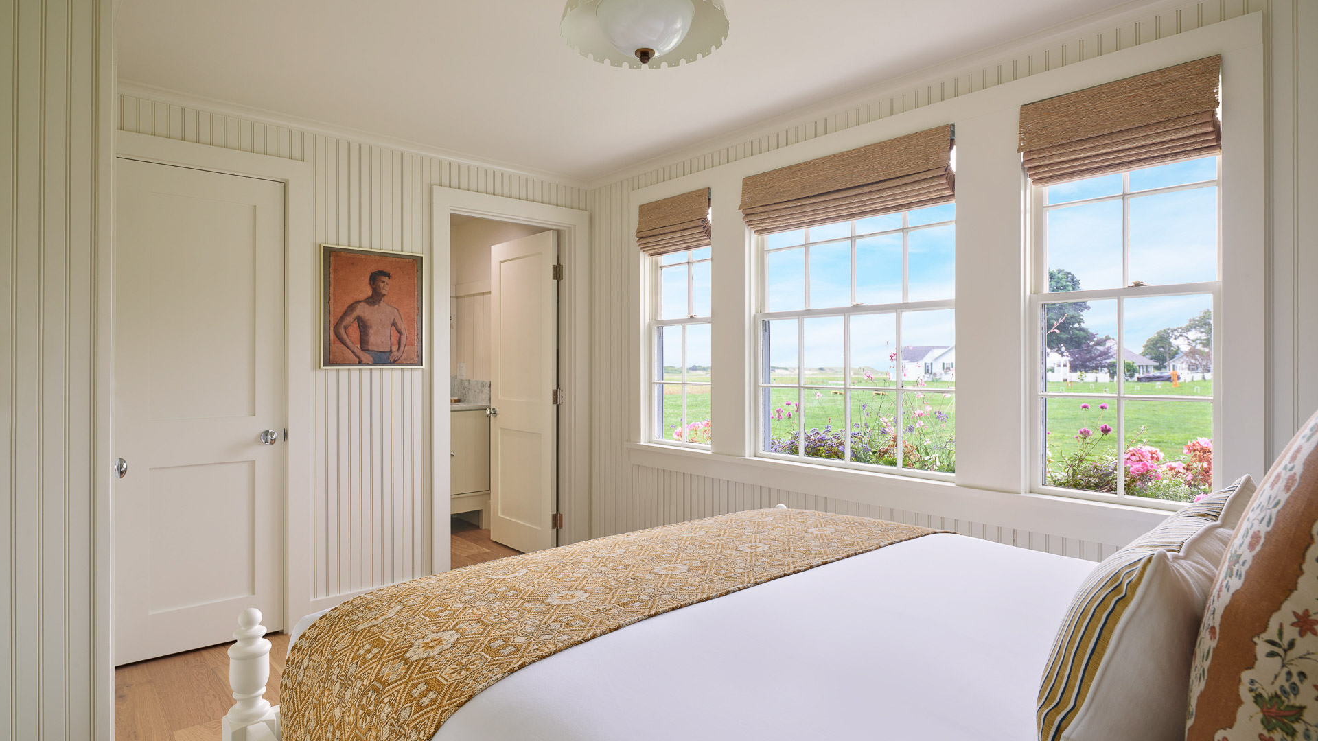 a bedroom with a bed and windows