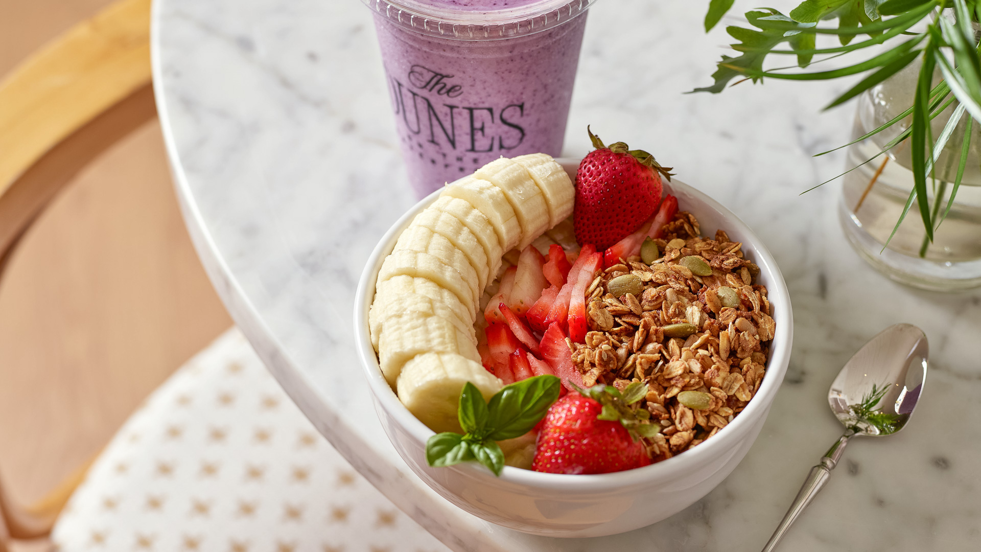 a bowl of fruit and a smoothie