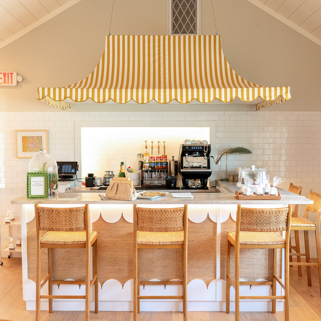 a coffee shop with a bar and chairs