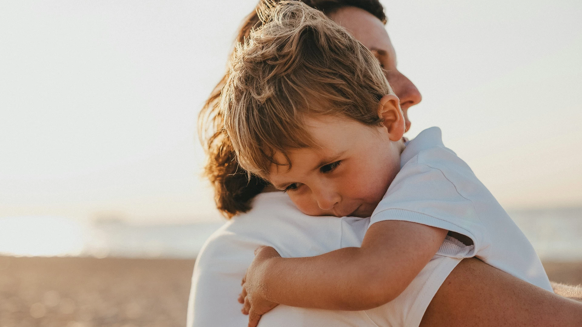 a child hugging a man