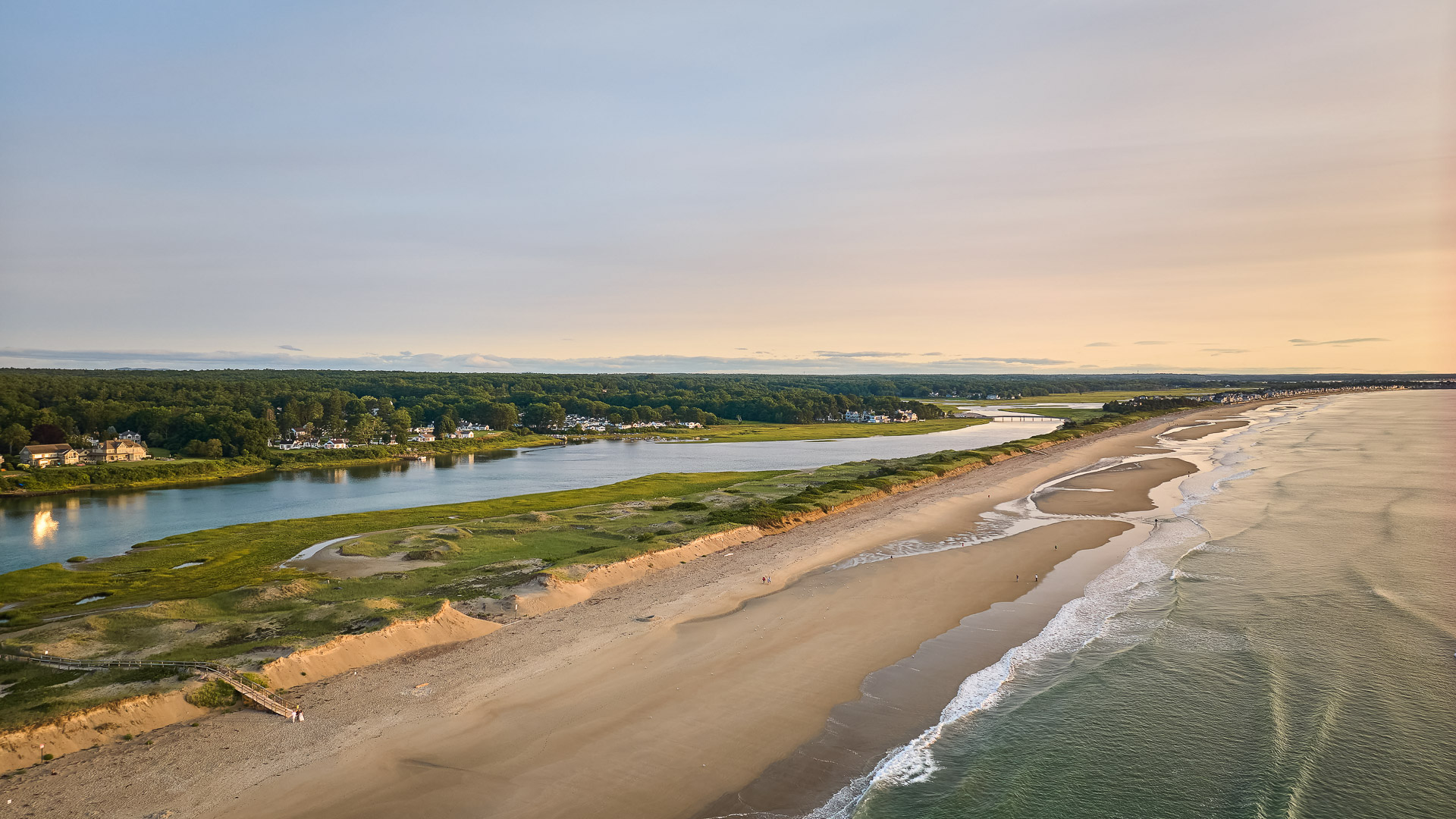 a beach with water and trees