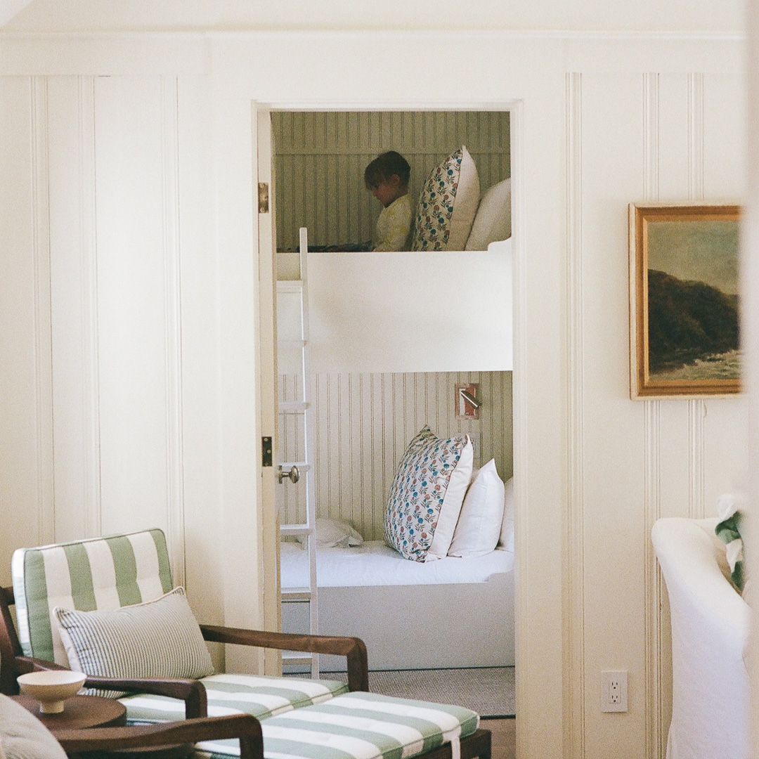 a room with a bed and chairs