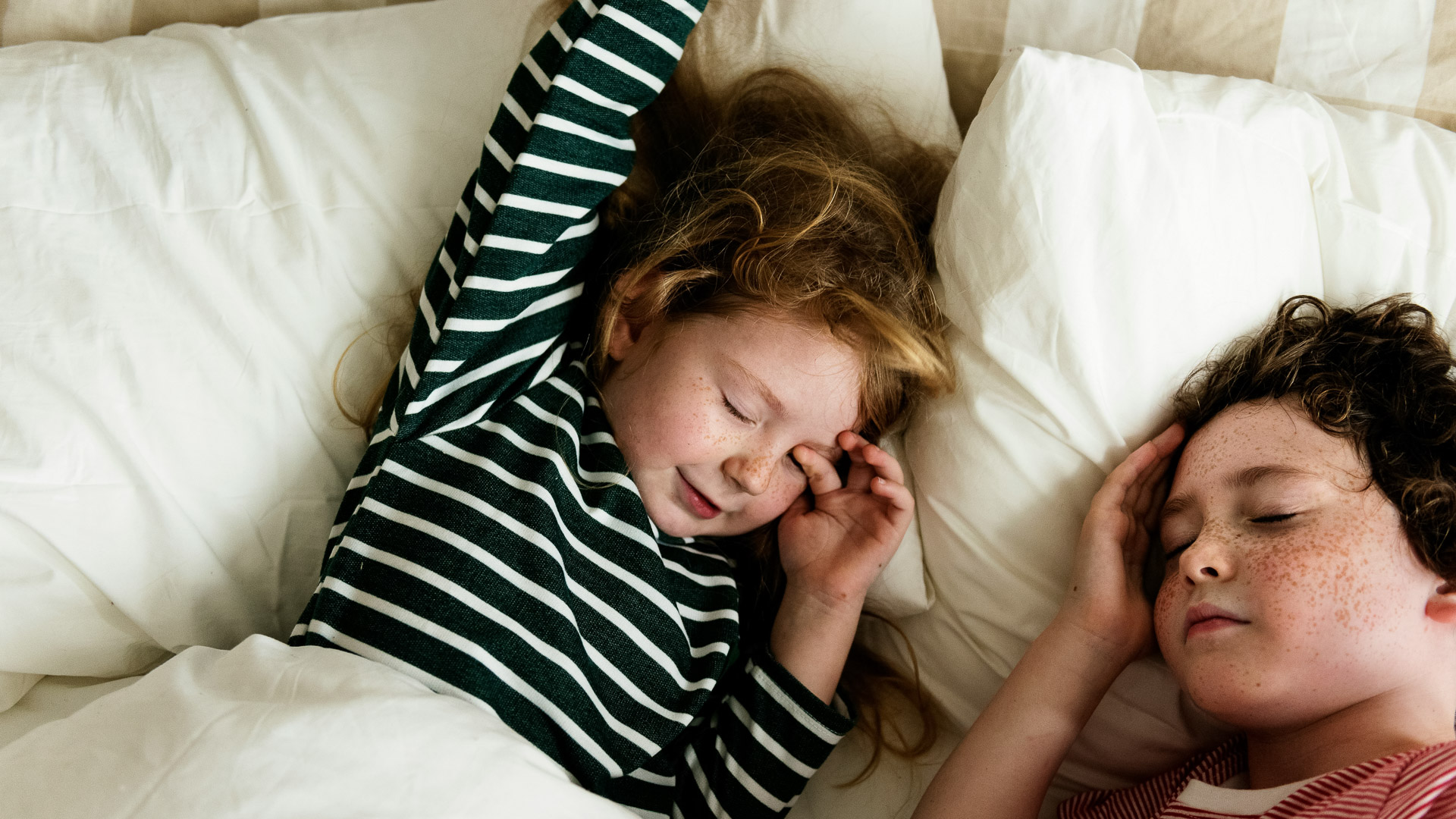 a girl sleeping in a bed