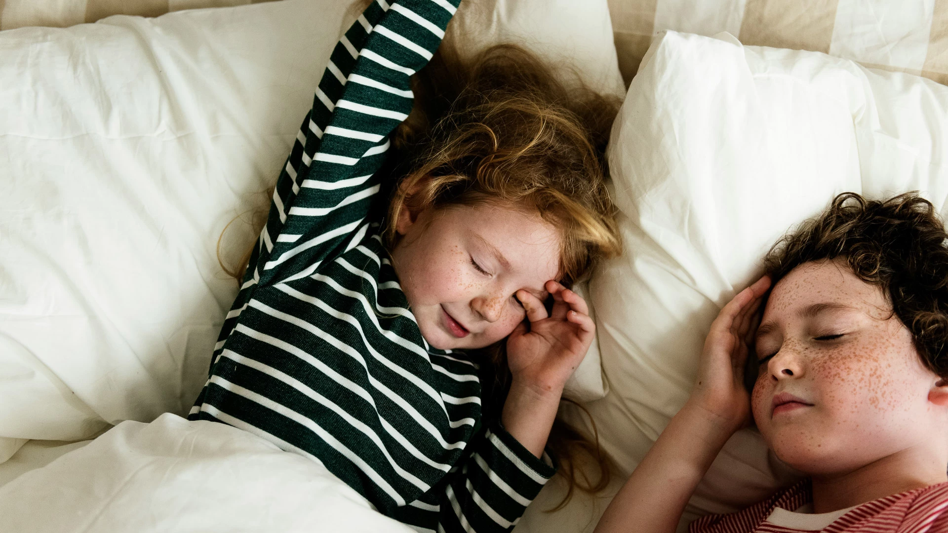 a girl sleeping in a bed