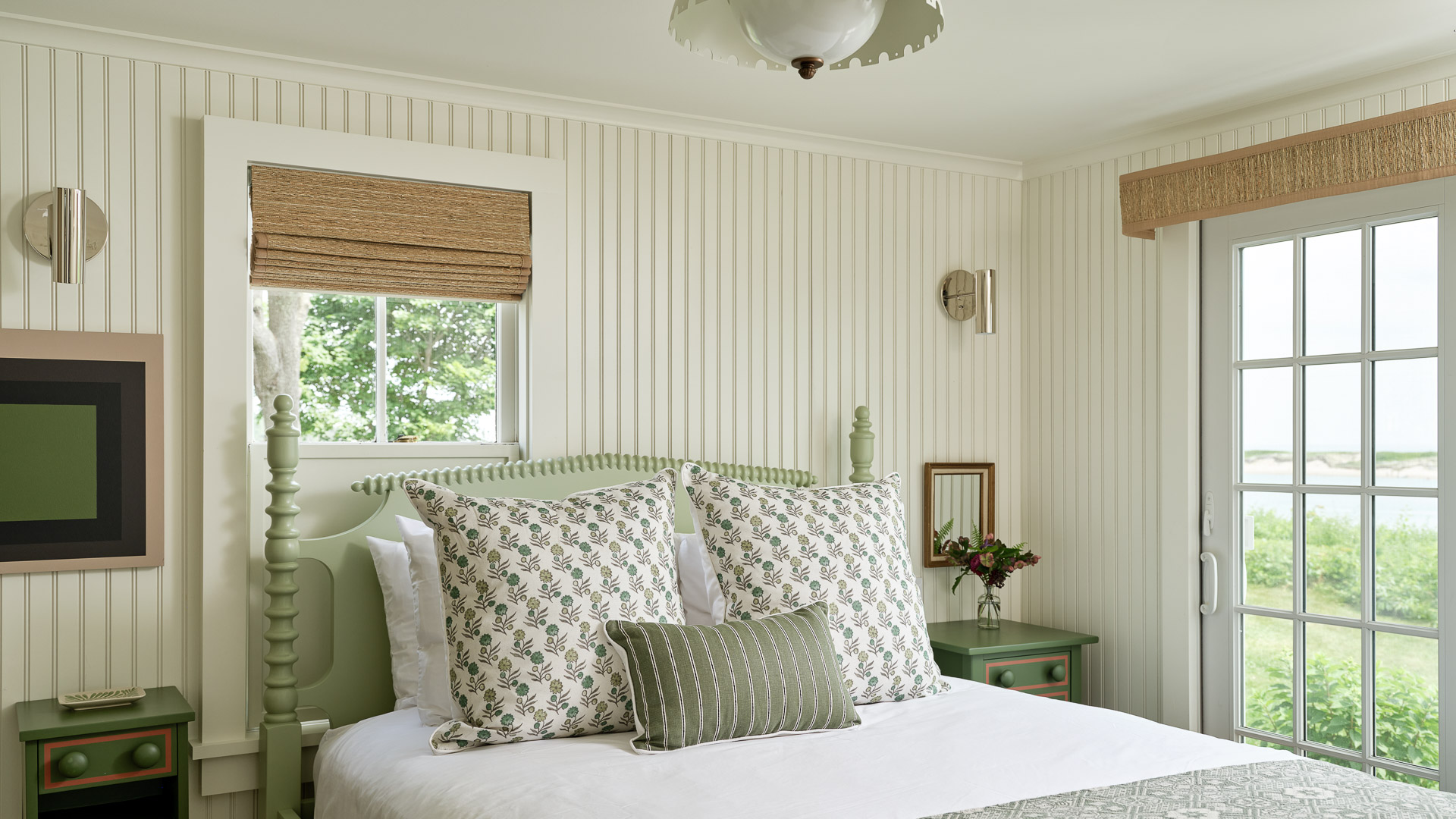 a bed with pillows and a lamp in a room