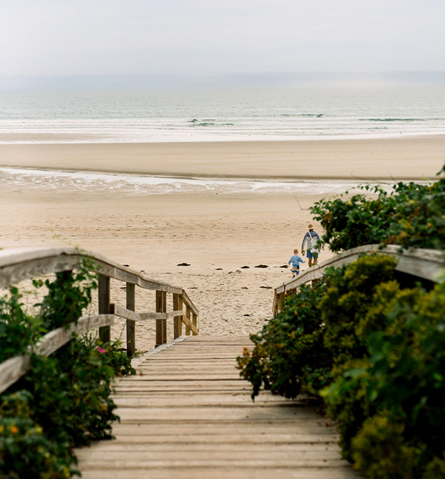 a wooden staircase leading to a beach