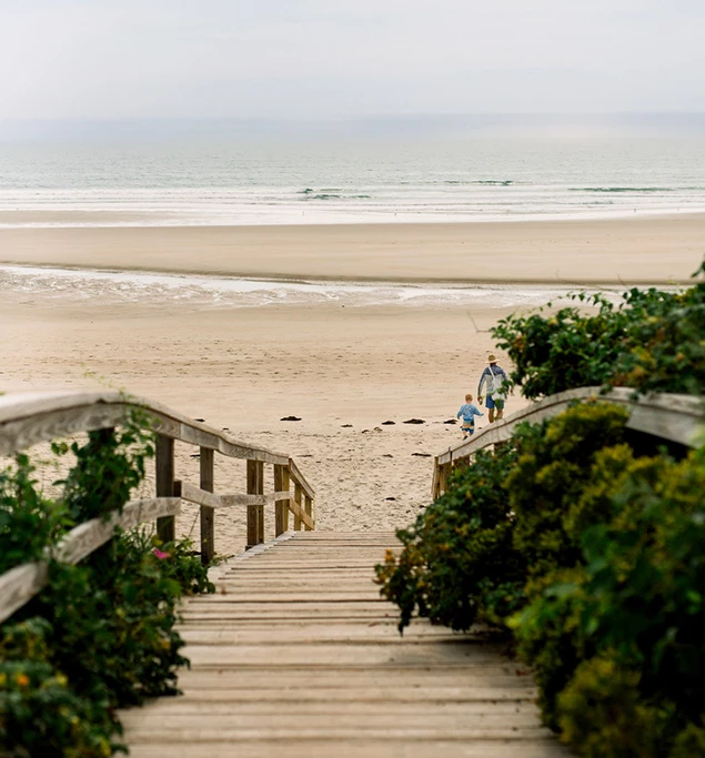 a wooden staircase leading to a beach
