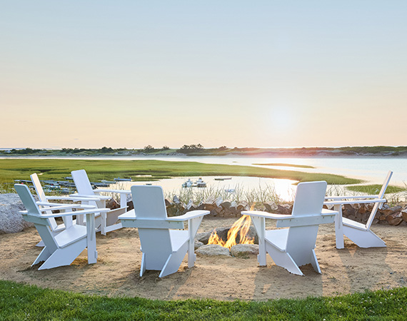 a group of chairs around a fire pit