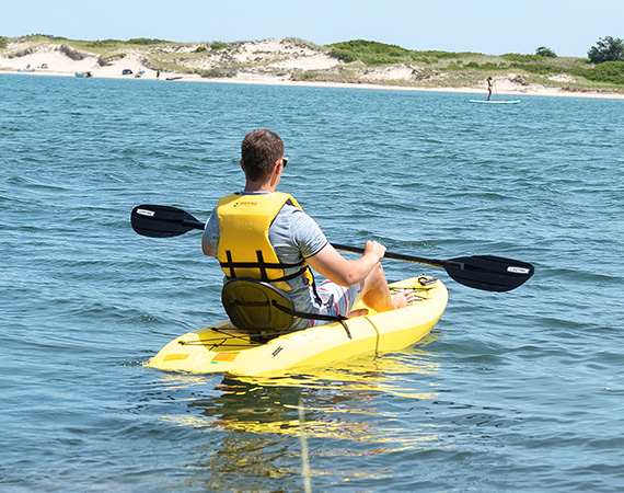 a man in a yellow kayak