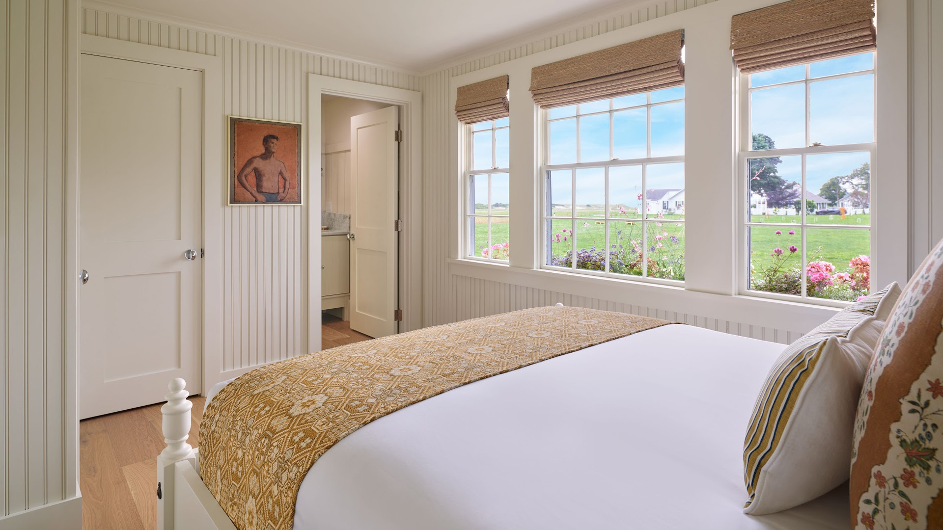 a bedroom with a bed and windows