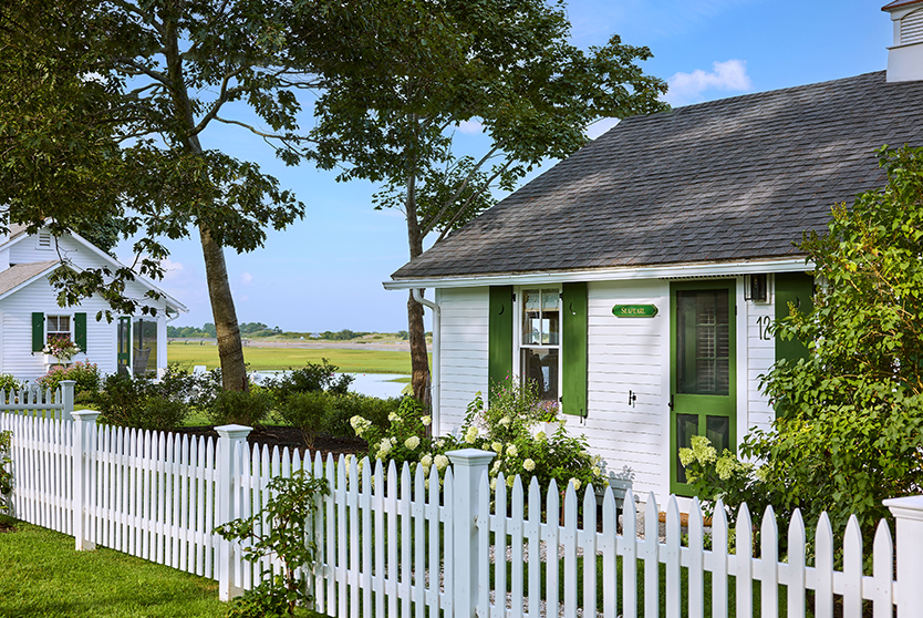 a white picket fence next to a house