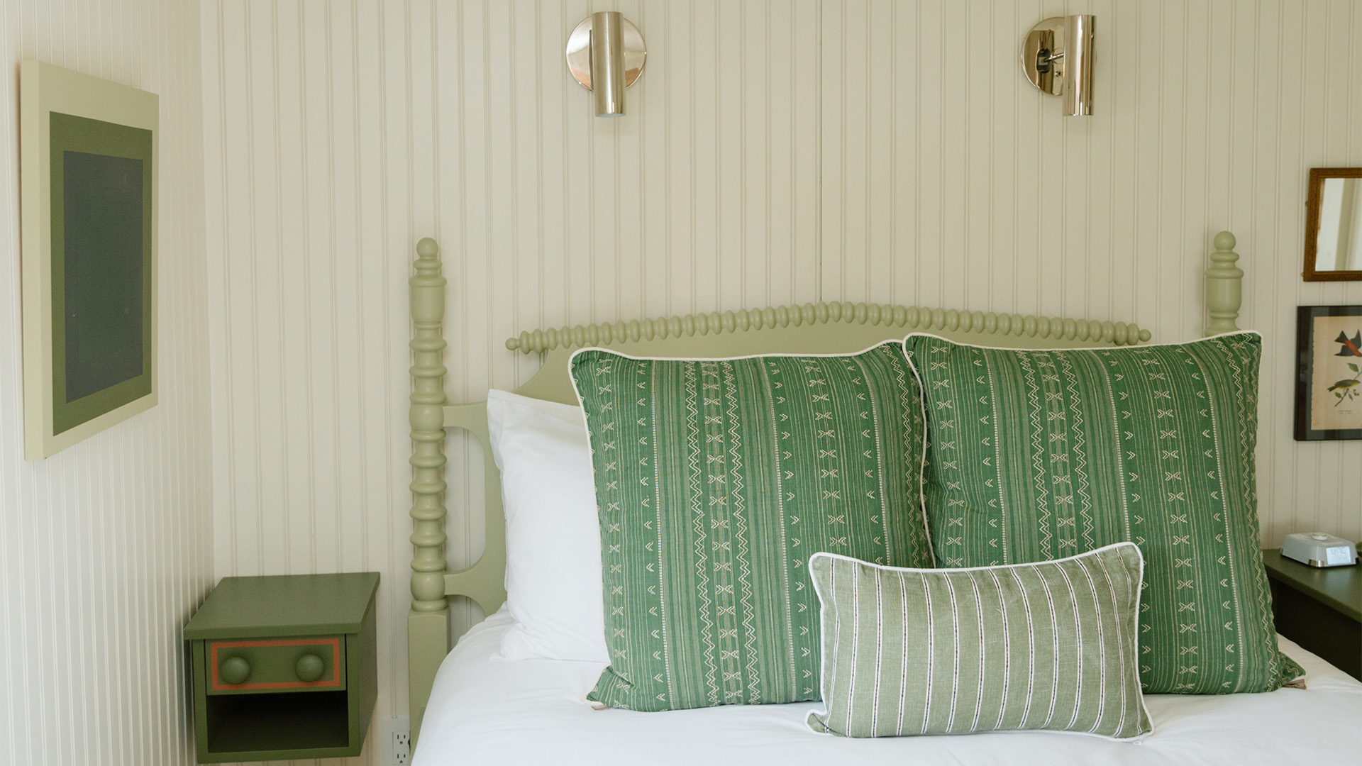 a green pillow on a bed