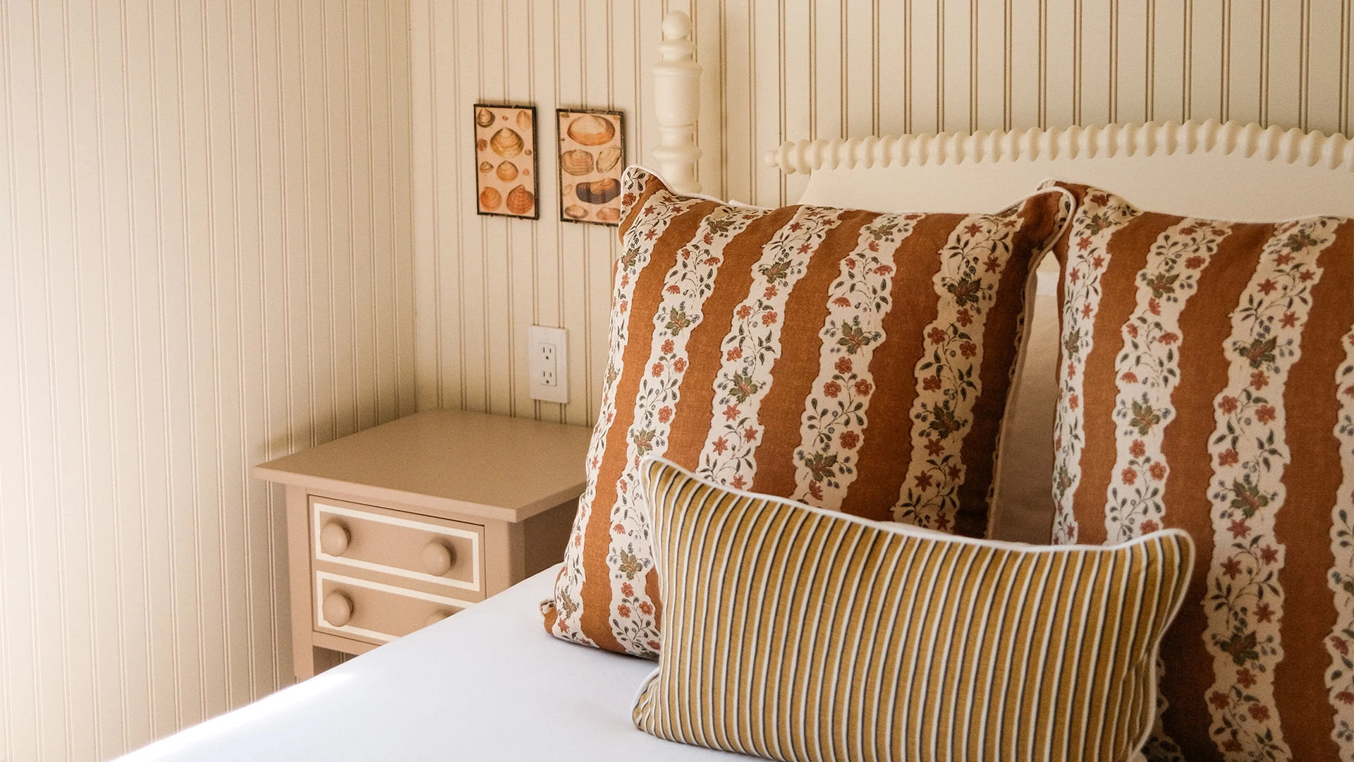 a bed with pillows and a nightstand