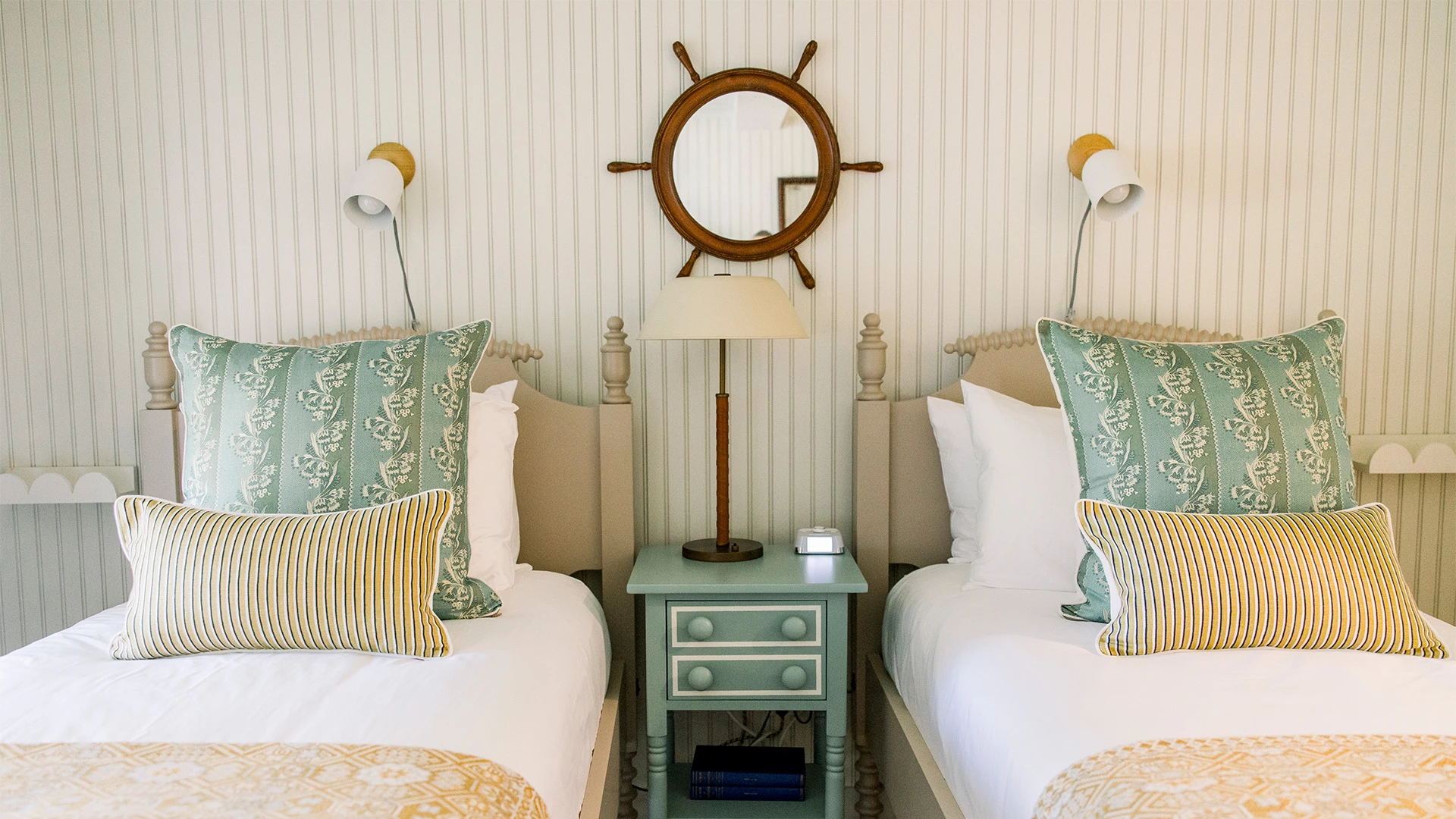 a room with two beds and a mirror