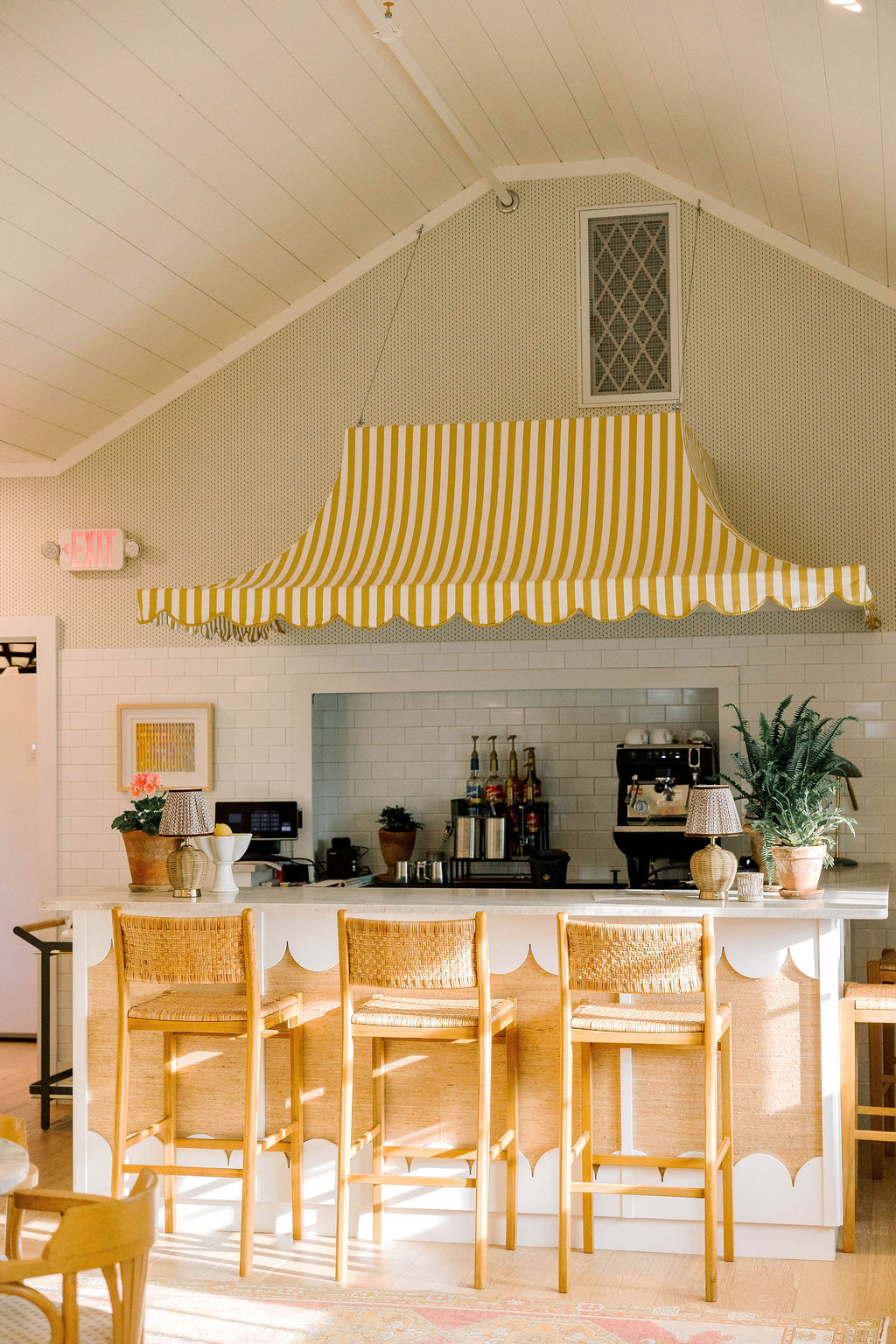 a room with a bar and chairs